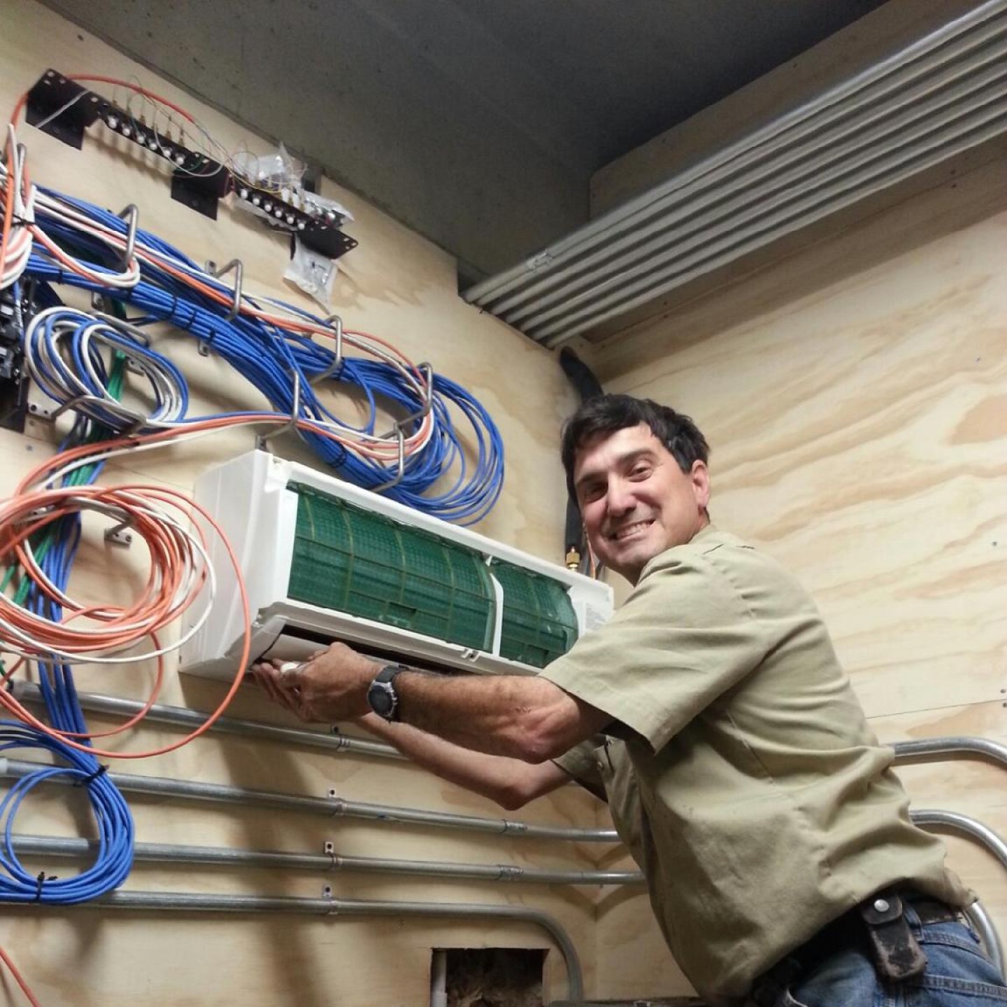 Bergen Plumbing technician installing AC